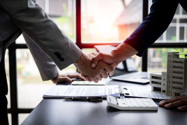 Successful handshake and agreement Real estate agent and client celebrating contracts completed after signing on home insurance and investment loans. house sale ideas